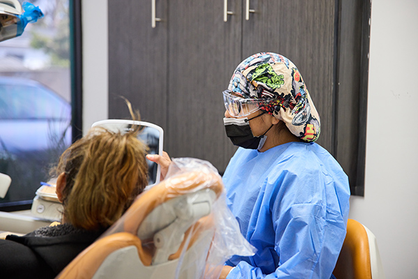 New patients at Gardena Dental Care smiling in the office